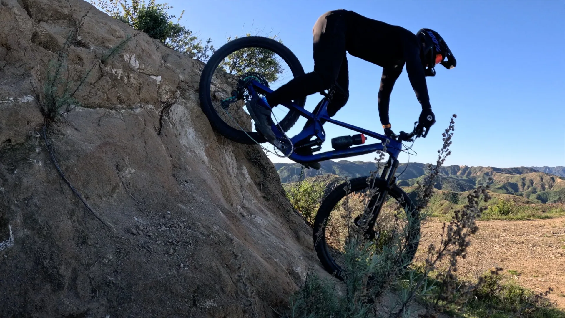Mountain biker dropping down a steep rock face in the Santa Monica Mountains