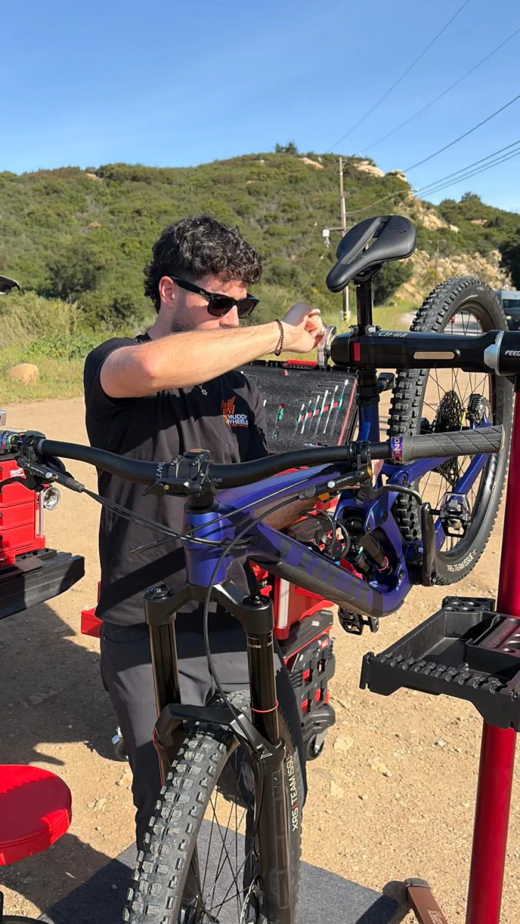 Adjusting suspension on a mountain bike mounted in the repair stand